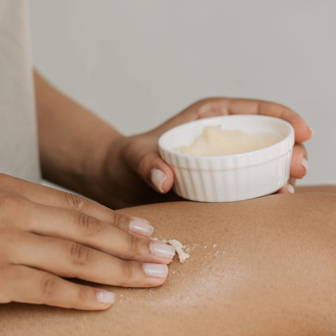 This is an image of a woman applying homemade scrub on skin